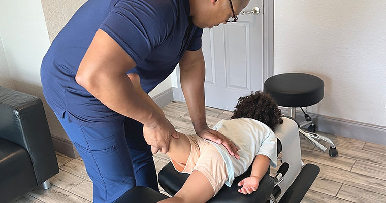 Lewisville Chiropractor making adjustment to a patient